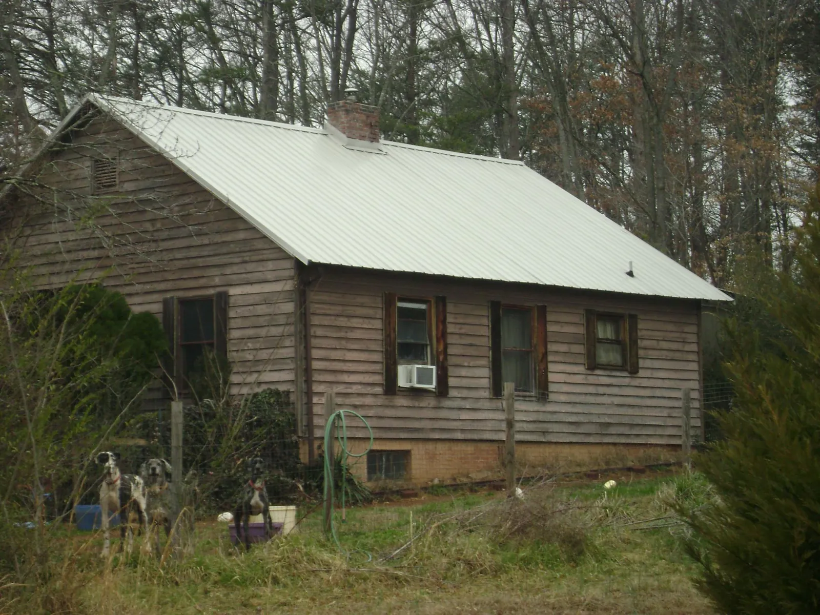 White metal roof on an old wood sided farmhouse, from a Metal Roof Installation job in Jeffersonton